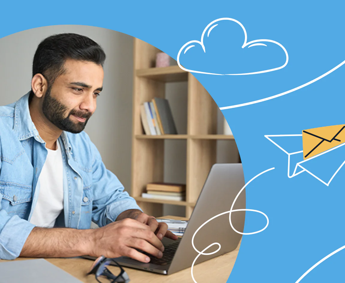 Man working on laptop with creative email illustration Man typing on laptop at desk with paper airplane and cloud graphics