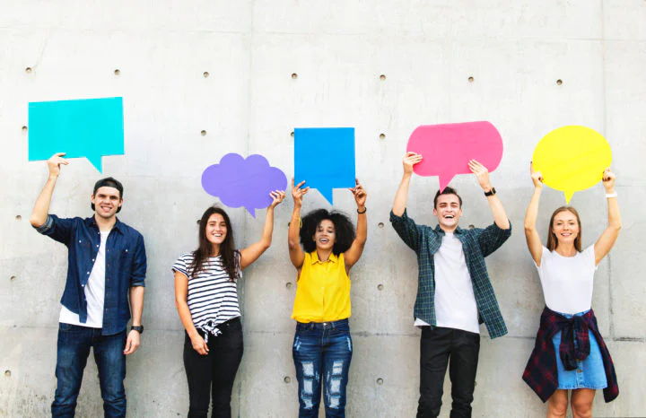 Group of young adults outdoors holding empty placard copyspace thought bubbles